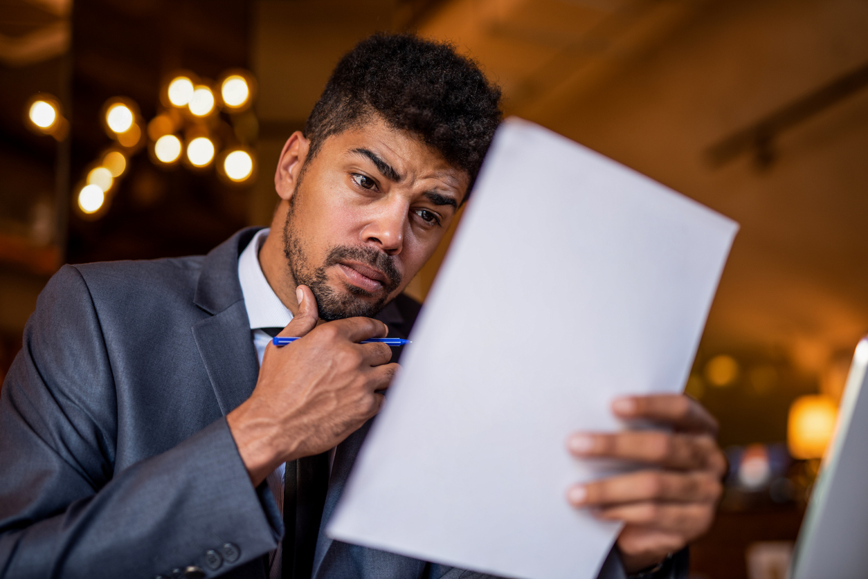 Mid adult African American businessman looking at paperwork.